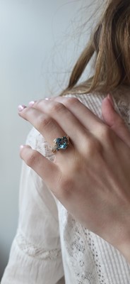 Lot 73 - A TOPAZ AND DIAMOND CLUSTER RING, the central...