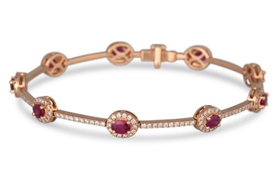Lot 309 - A DIAMOND AND RUBY CLUSTER BRACELET, mounted...