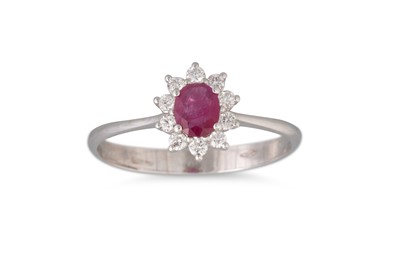 Lot 140 - A RUBY AND DIAMOND CLUSTER RING, the oval ruby...