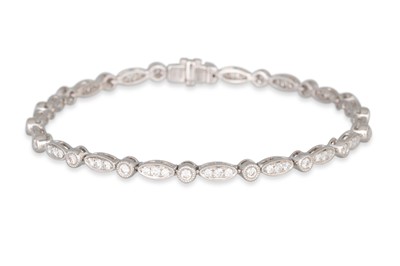 Lot 355 - A DIAMOND LINE BRACELET, comprising oval...