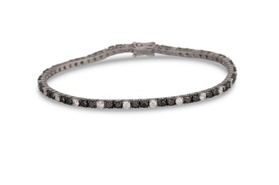 Lot 356 - A BLACK AND WHITE DIAMOND LINE BRACELET,...