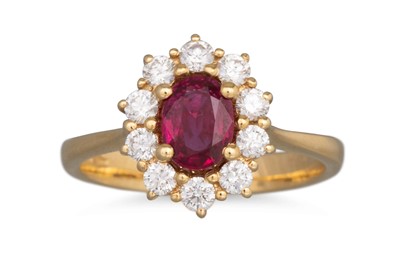 Lot 358 - A DIAMOND AND RUBY CLUSTER RING, the oval ruby...