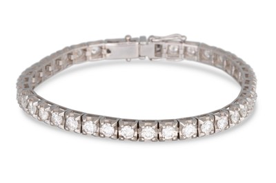 Lot 382 - A DIAMOND LINE BRACELET, the brilliant cut...