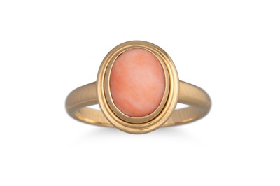 Lot 144 - A CORAL RING, the cabochon stone mounted in...
