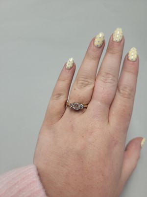 Lot 2 - A THREE STONE DIAMOND RING, set with an...