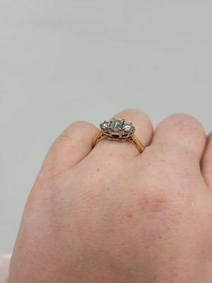 Lot 2 - A THREE STONE DIAMOND RING, set with an...