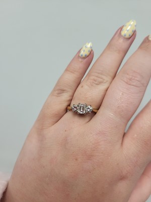 Lot 2 - A THREE STONE DIAMOND RING, set with an...