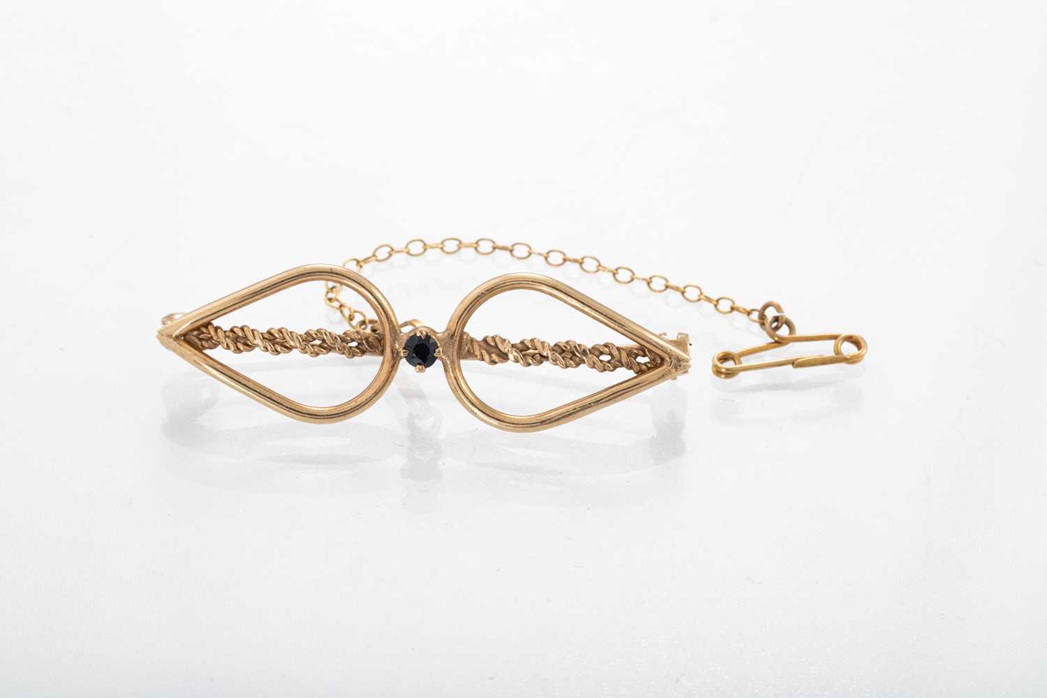 Lot 96 - A SAPPHIRE OPEN BOW BROOCH, mounted in gold,...