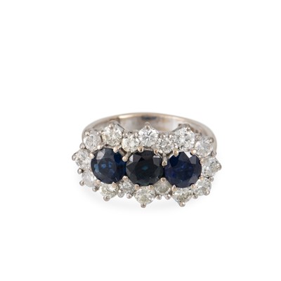 Lot 20 - A DIAMOND AND SAPPHIRE CLUSTER RING, the three...