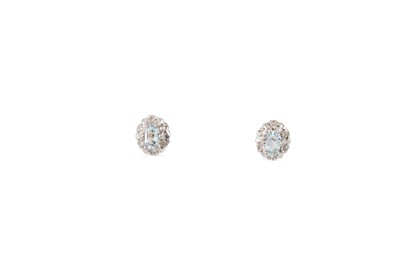 Lot 21 - A PAIR OF DIAMOND AND TOPAZ EARRINGS, the oval...