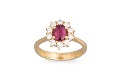 Lot 125 - A DIAMOND AND RUBY CLUSTER RING, the oval ruby...