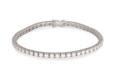 Lot 269 - A DIAMOND LINE BRACELET, the brilliant cut...