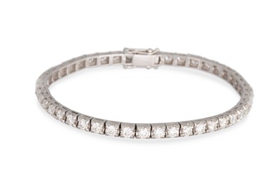 Lot 283 - A DIAMOND LINE BRACELET, the brilliant cut...