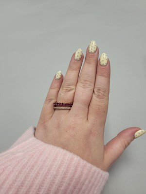 Lot 187 - A RUBY AND DIAMOND RING, comprising a row of...