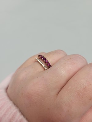 Lot 187 - A RUBY AND DIAMOND RING, comprising a row of...