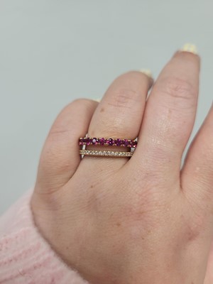 Lot 187 - A RUBY AND DIAMOND RING, comprising a row of...