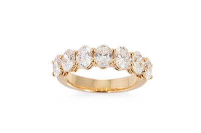 Lot 230 - A SEVEN STONE OVAL DIAMOND RING, mounted in...