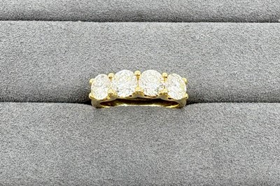 Lot 234 - A FOUR STONE DIAMOND RING, the round brilliant...