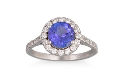 Lot 192 - A TANZANITE AND DIAMOND CLUSTER RING, of oval...