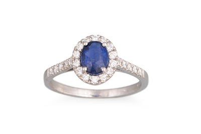 Lot 240 - A SAPPHIRE AND DIAMOND CLUSTER RING, the oval...