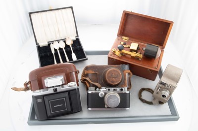 Lot 215 - A LEICA CAMERA, No 137944, brown leather case,...