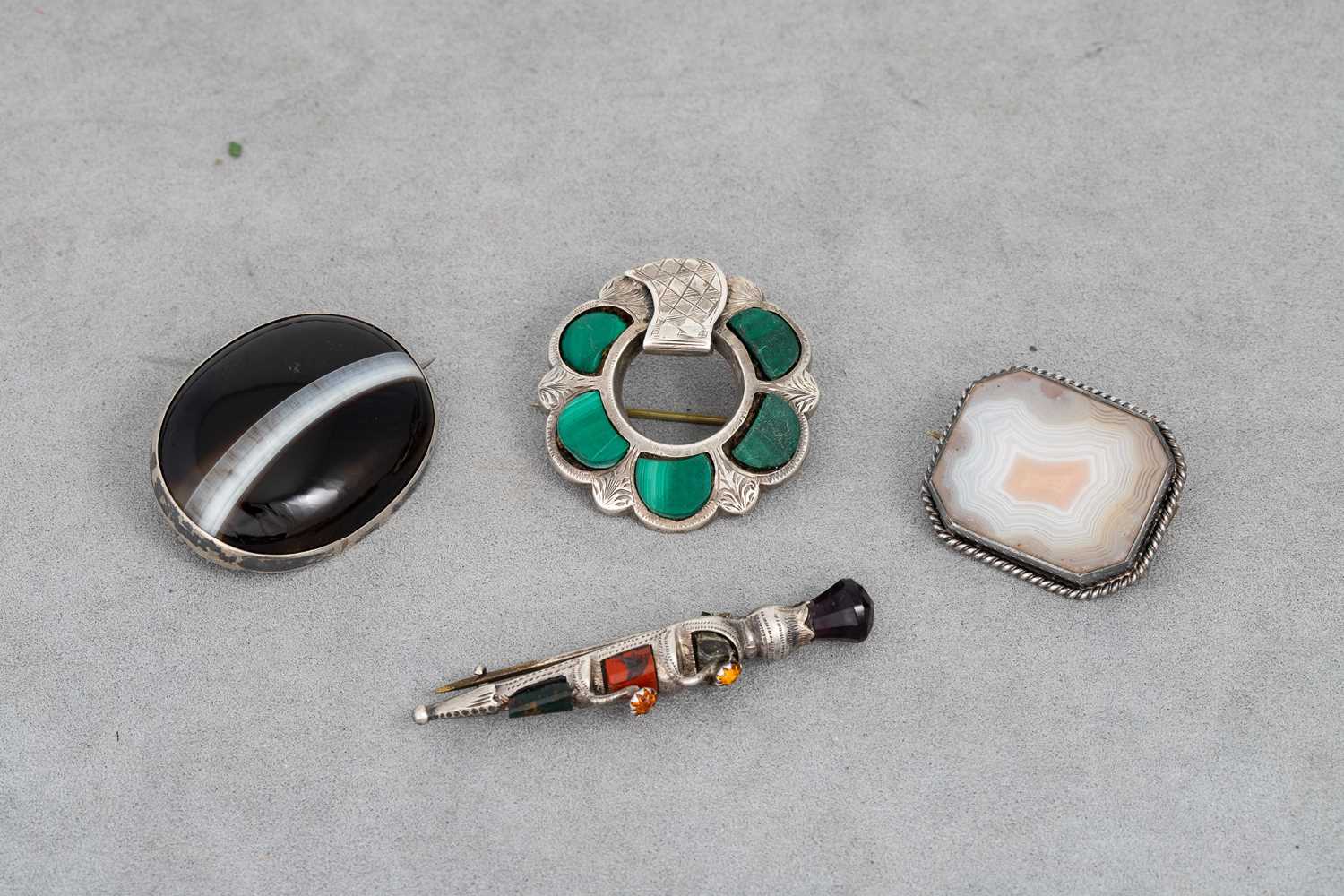 Lot 29 - FOUR VICTORIAN SCOTTISH PEBBLE BROOCHES,...