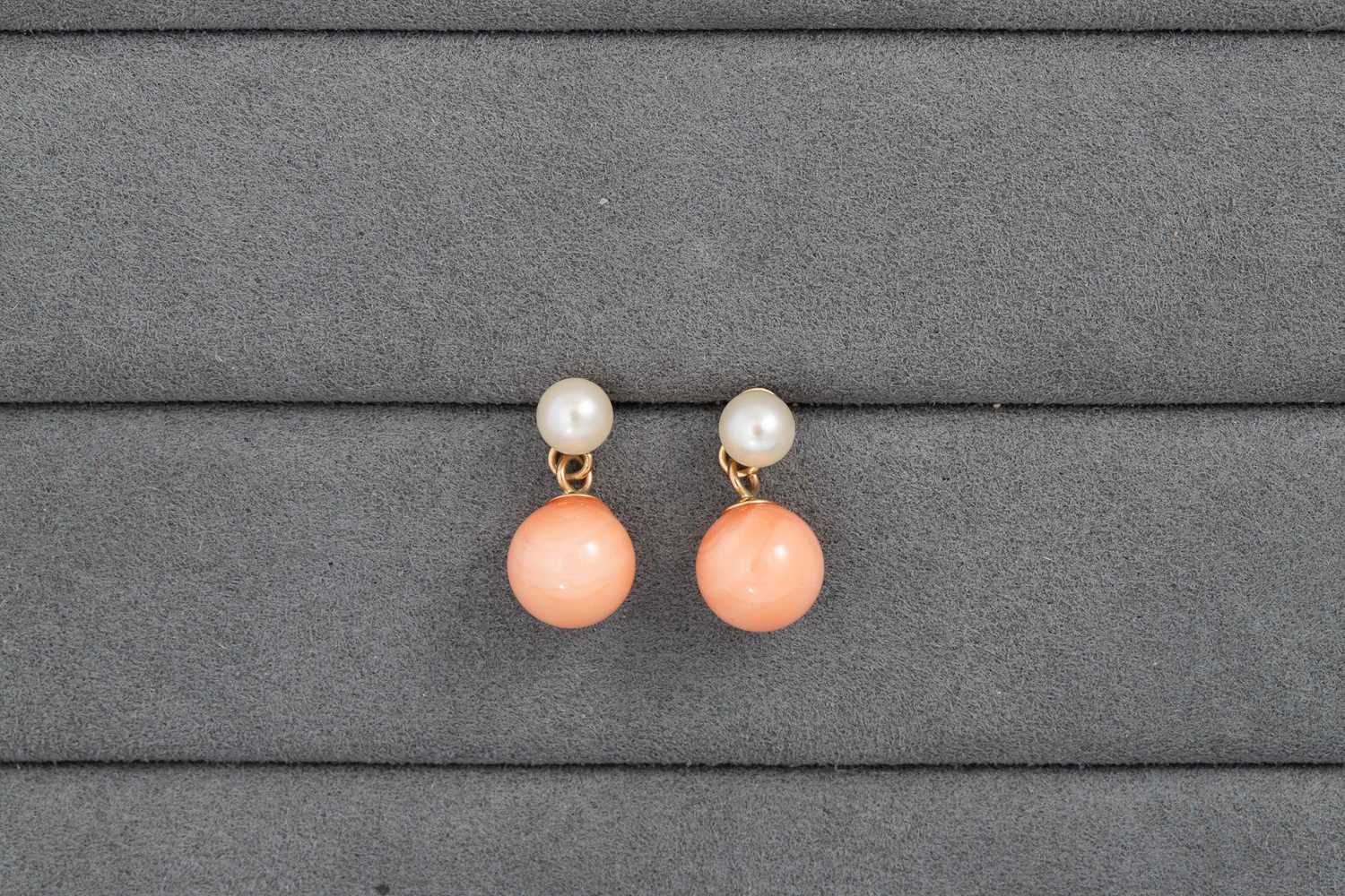 Lot 33 - A PAIR OF PEARL AND CORAL EARRINGS, mounted in...