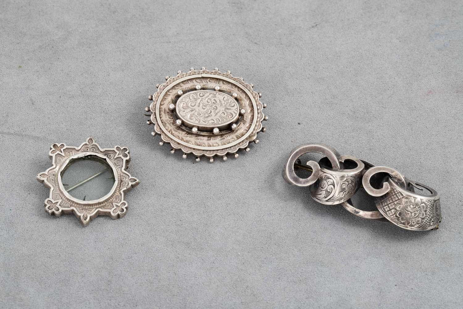Lot 34 - THREE VICTORIAN STYLE SILVER BROOCHES, two...