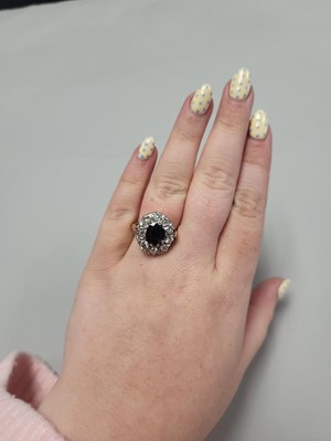 Lot 20 - A DIAMOND AND SAPPHIRE CLUSTER RING, the oval...