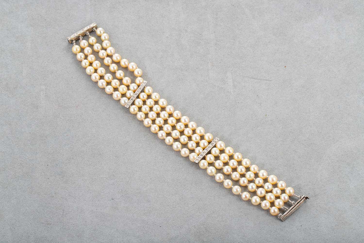 Lot 26 - A FOUR STRAND CULTURED PEARL BRACELET, with...