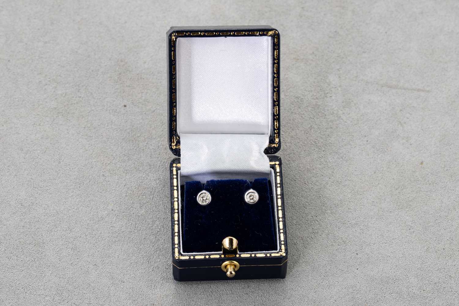 Lot 30 - A PAIR OF DIAMOND STUD EARRINGS, the round...