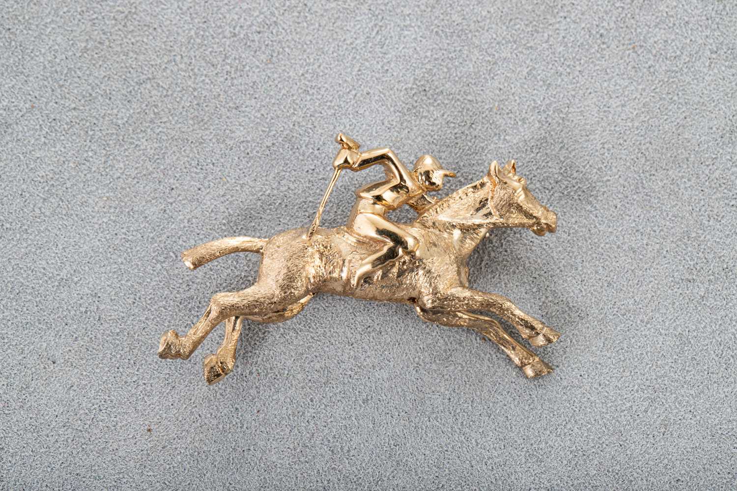 Lot 32 - A 9CT GOLD EQUESTRIAN BROOCH, modelled as a...
