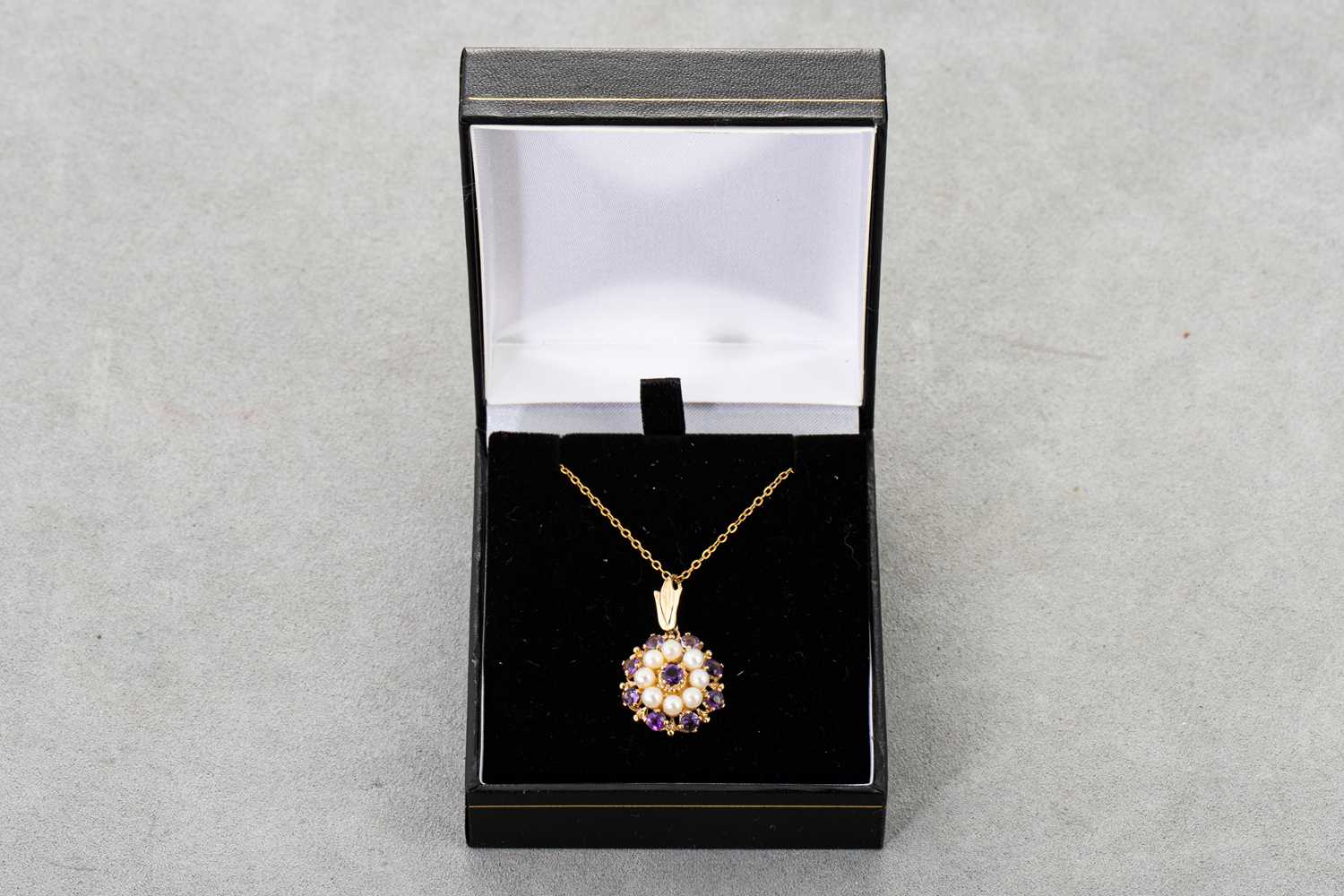 Lot 71 - AN AMETHYST AND PEARL CLUSTER PENDANT, mounted...