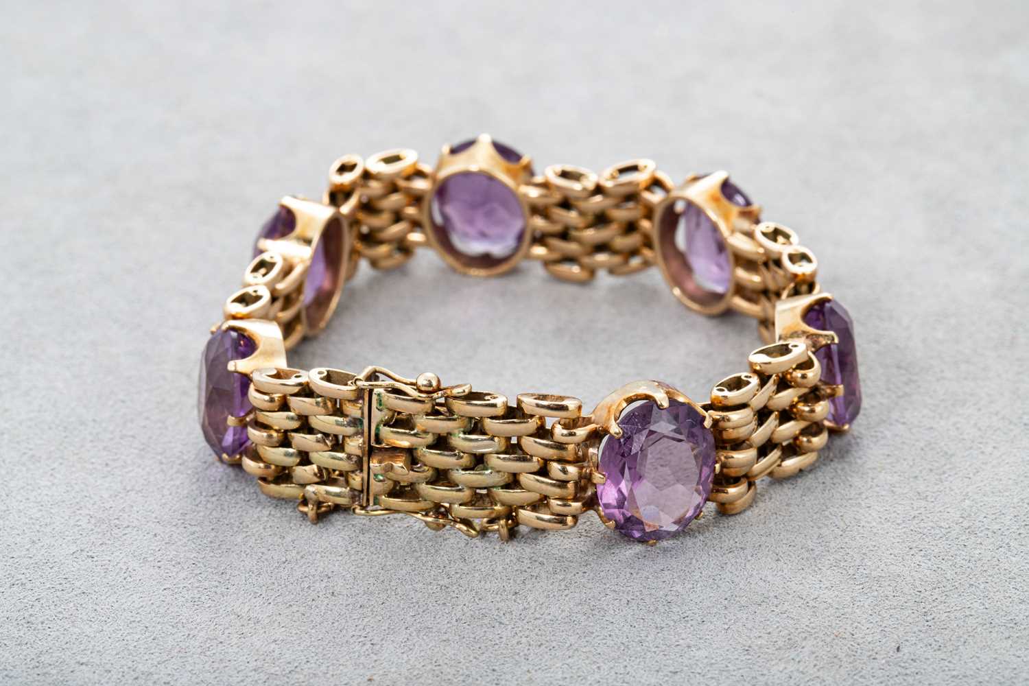 Lot 76 - AN AMETHYST BRACELET, set with oval mixed cut...