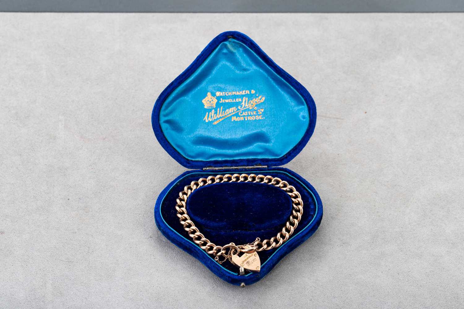 Lot 77 - A 9CT GOLD CURB LINK BRACELET, engraved...