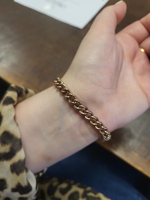 Lot 77 - A 9CT GOLD CURB LINK BRACELET, engraved...