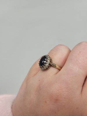 Lot 79 - A DIAMOND AND SAPPHIRE CLUSTER RING, the oval...