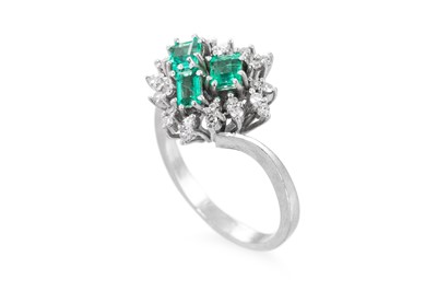 Lot 179 - AN EMERALD AND DIAMOND CLUSTER RING, set with...