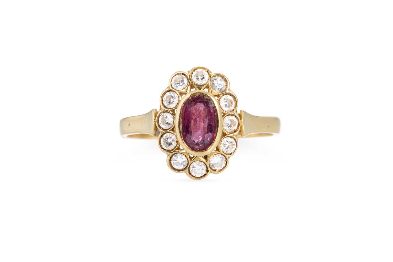 Lot 130 - A RUBY AND DIAMOND CLUSTER RING, the oval ruby...