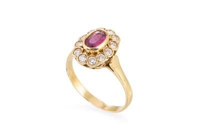 Lot 130 - A RUBY AND DIAMOND CLUSTER RING, the oval ruby...