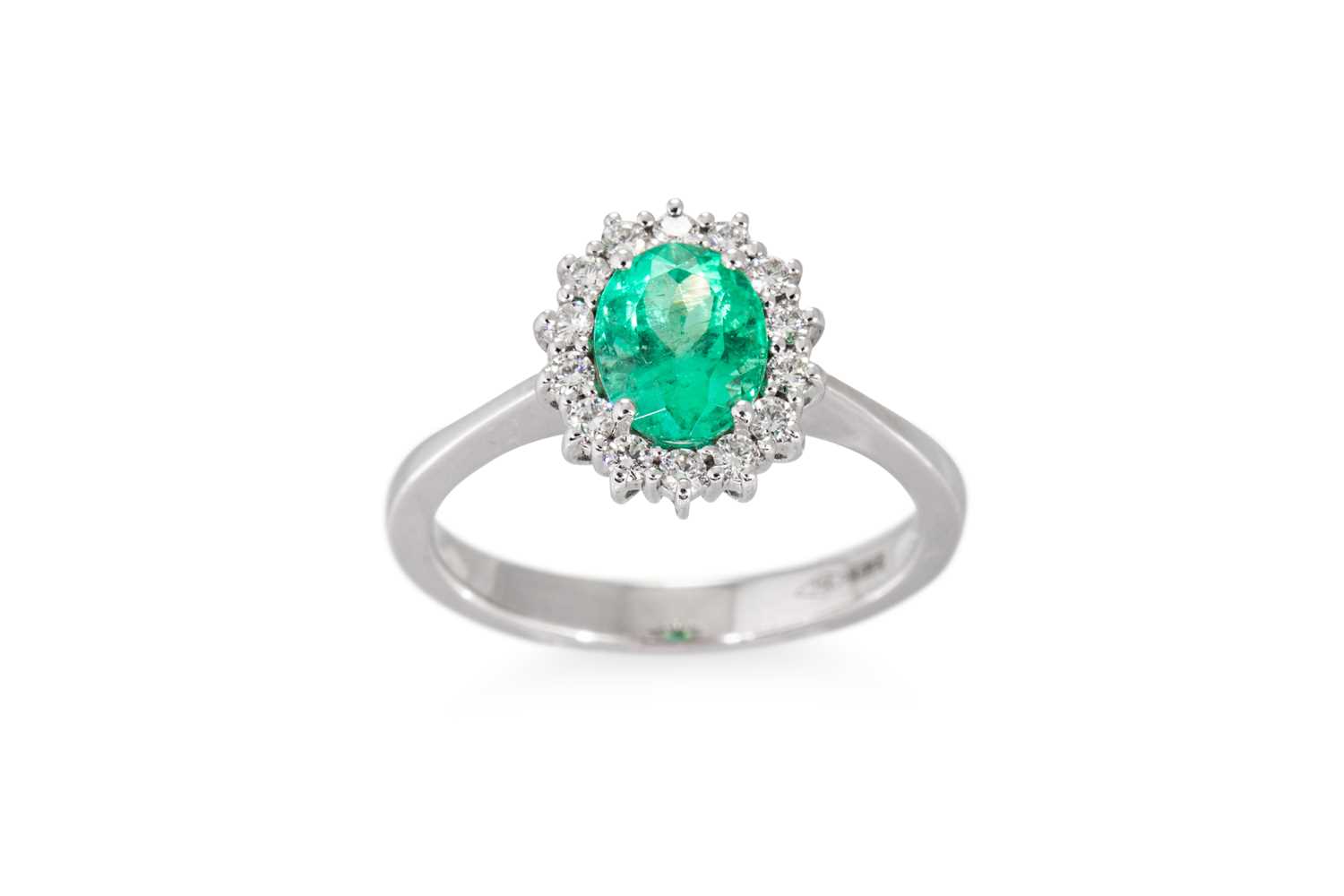 Lot 133 - AN EMERALD AND DIAMOND CLUSTER RING, the oval...
