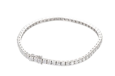 Lot 149 - A DIAMOND LINE BRACELET, the round brilliant...