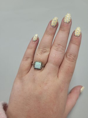 Lot 1 - A SYNTHETIC OPAL AND DIAMOND RING, mounted in...