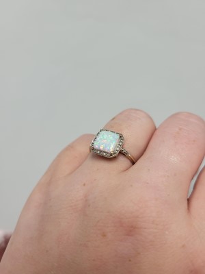 Lot 1 - A SYNTHETIC OPAL AND DIAMOND RING, mounted in...