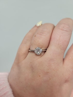 Lot 154 - A DIAMOND CLUSTER RING, set with marquise and...