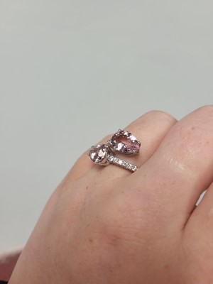 Lot 158 - A MORGANITE AND DIAMOND RING, of cross over...