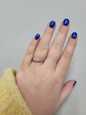 Lot 38 - A PINK SAPPHIRE ETERNITY RING, set with...