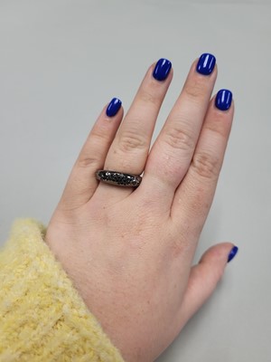 Lot 39 - A BLACK DIAMOND BOMBÉ RING, pavé set in black...