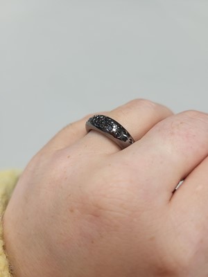 Lot 39 - A BLACK DIAMOND BOMBÉ RING, pavé set in black...