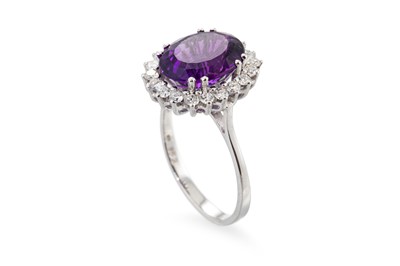 Lot 116 - AN AMETHYST AND DIAMOND RING, the oval...